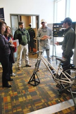 John Holt, Jeff Aland and Blake Holden, three Biosystems Engineering majors explain how to create energy from a bicycle. Carolyn Rush / ASSISTANT PHOTO EDITOR