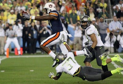 Kodi Burns jumps over Talmadge Jackson to score an Auburn touchdown in second quarter. (Emily Adams/PHOTO EDITOR)