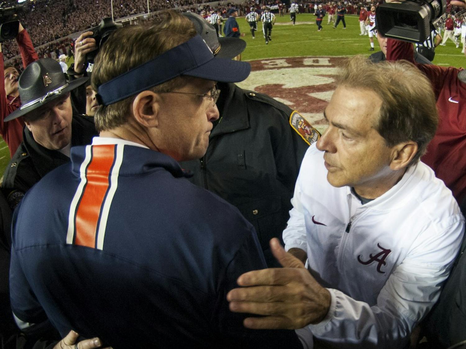 Coaches Gus Malzahn and Nick Saban meet on the field following Auburn's 30-12 loss to Alabama. Auburn vs Alabama on Saturday, Nov. 26 in Tuscaloosa, Ala.
