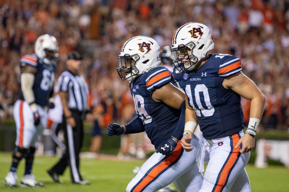 Bo Nix (10) runs to the sideline with JaTarvious Whitlow (28) during Auburn vs. Kent State, on Saturday, Sept. 14, 2019, in Auburn, Ala.