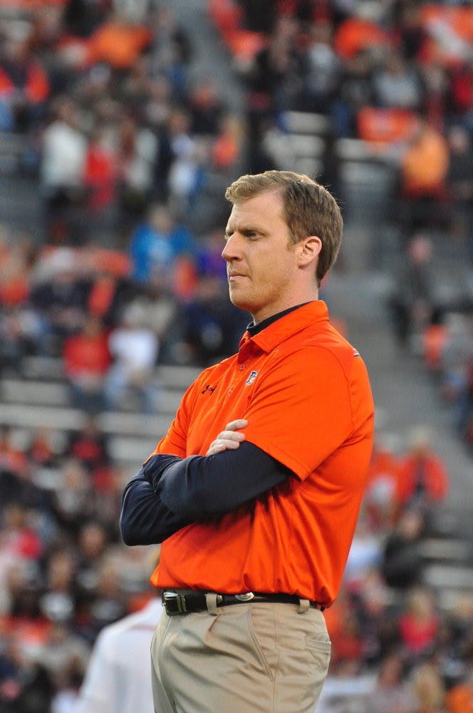 Rhett Lashlee watches warm up drills before the game on Saturday. Anna Grafton / PHOTO EDITOR