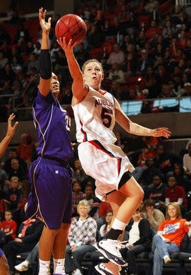 Auburn's Alli Smalley lays in a basket around LSU's Taylor Turnbow in the first half. Auburn won 65-53. (Todd Van Emst / Auburn Media Relations)