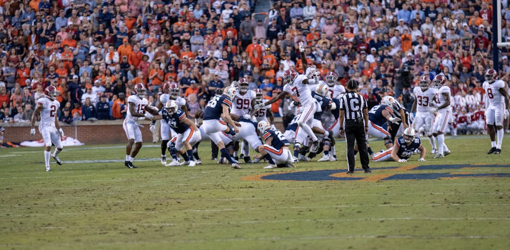 <p>Anders Carlson (26) makes a 52-yard field goal with 1 second left on the first-half clock during Auburn vs. Alabama on Nov. 30, 2019, in Auburn, Ala. Trevon Diggs (7) ran into Carlson after the play.</p>