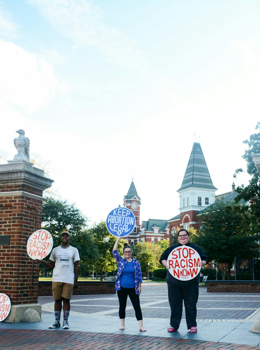 <p>Founder, Kelli Thompson, and respective Toomer's sit-in members pose with their signs of protest, 500 days after the initial sit-in.</p>
