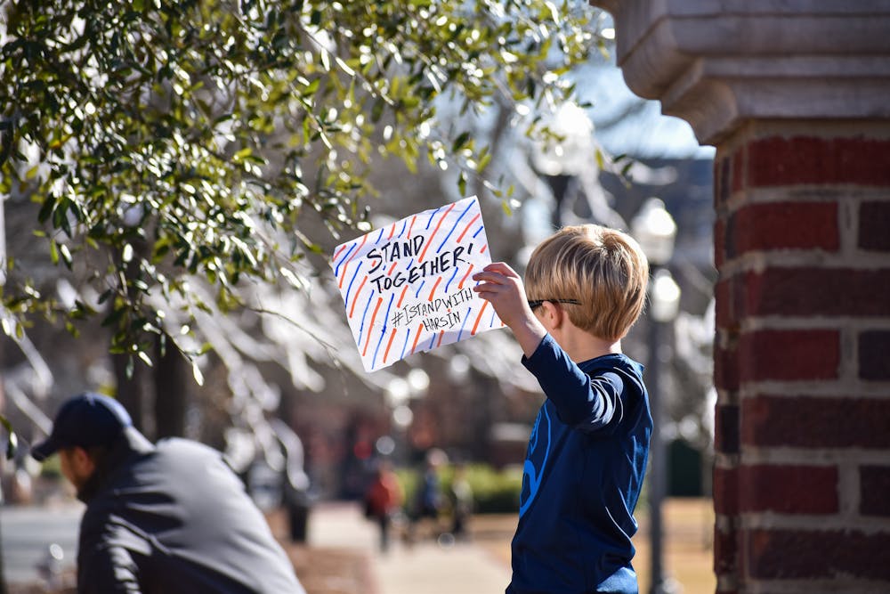 <p>Auburn fans and community members gather at Toomer's Corner to show support for Auburn head football coach Bryan Harsin on Feb. 6, 2022, in Auburn, Ala.&nbsp;</p>