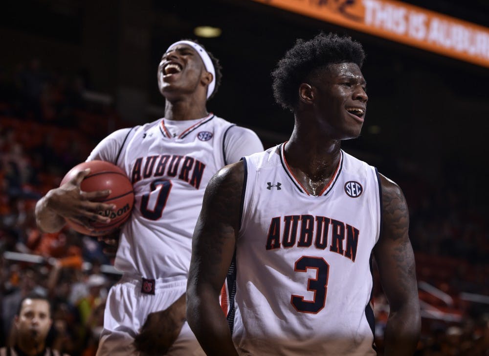 <p>Danjel Purifoy (3) celebrates with Horace Spencer (0) in the background during the second half of a NCAA college basketball game, Monday, Nov. 14, 2016, in Auburn, Ala. </p>
