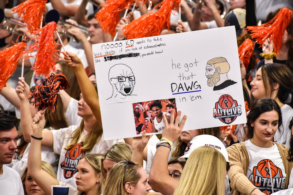 Auburn fans hold up signs ahead of College Game Day's appearance on campus on Feb. 12, 2022.