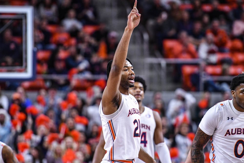 Auburn forward Yohan Traore (21) points to the sky after scoring a bucket against Colgate in Neville Arena on Dec. 2, 2022.