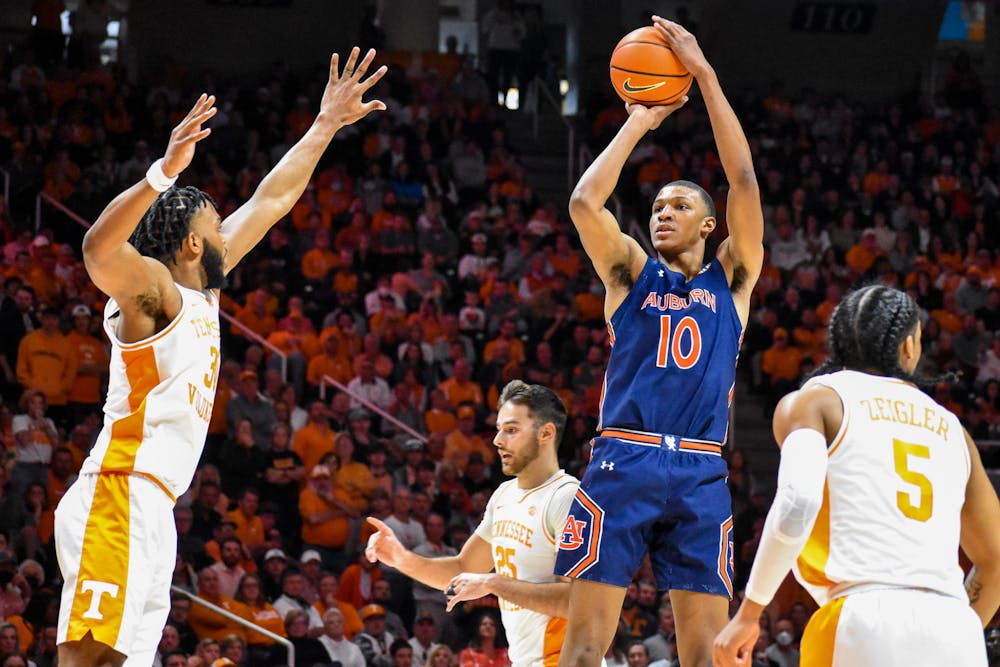 <p>Jabari Smith (10) fires off a three-point shot during the second half of a match between Auburn and Tennessee in the Thompson-Boling Arena on Feb. 26, 2022.</p>