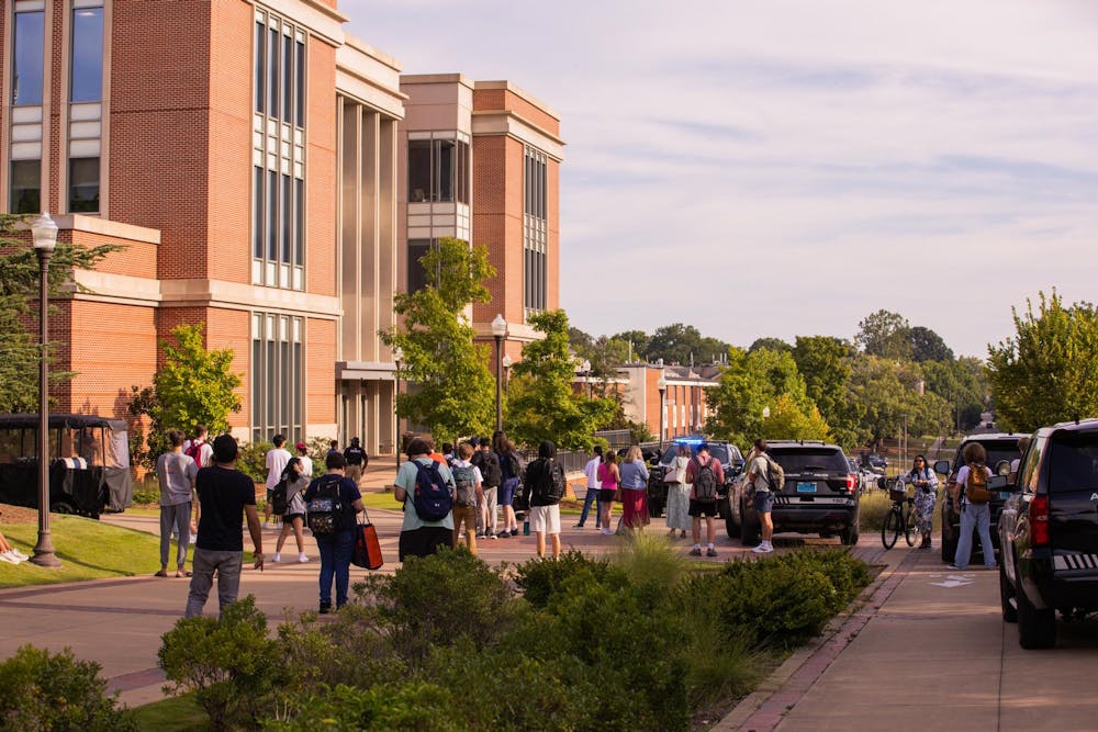 <p>Students wait outside the Ralph B Draughon Library after an AU Alert was sent out asking students stay clear of the area on August 27, 2025.</p>