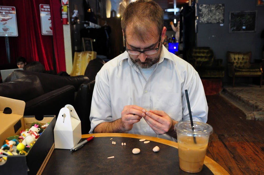 Ari Gutman, Auburn University lecturer, works on a sculpture of a bee at Mama Mocha's Coffee Emporium in Auburn, Ala., on Wednesday, April 19, 2017.