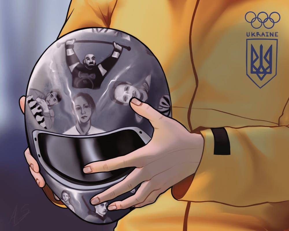<p>A person in a yellow jacket holds a black helmet featuring various portraits and the Ukrainian Olympic emblem.</p>