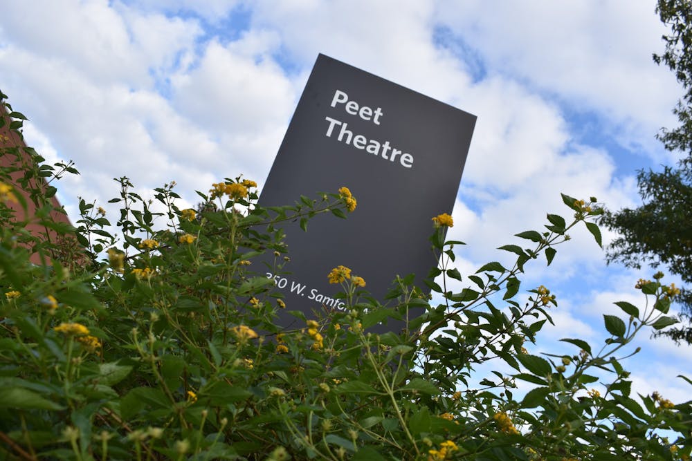 <p>The Peet Theater sign on Auburn University's campus surrounded by wildflowers on Saturday, October 31, 2020.&nbsp;</p>