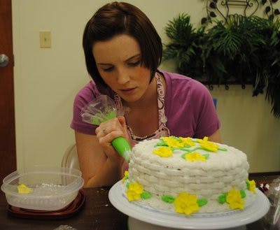 Rebecca Simmons, second-year pharmacy student, applies the last-minute touches to her final project in last week's cake-decorating class. (Elaine Busby / ASSISTANT PHOTO EDITOR)