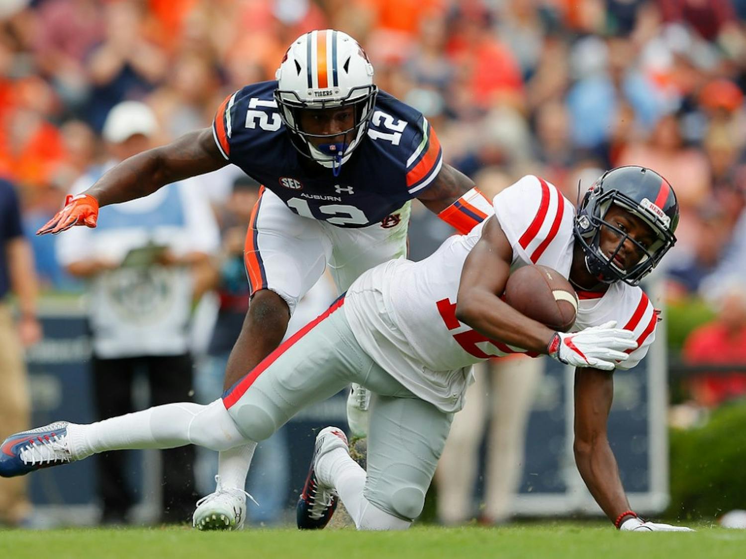 Van Jefferson #12 of the Mississippi Rebels fails to pull in this reception against Jamel Dean #12 of the Auburn Tigers at Jordan Hare Stadium on October 7, 2017 in Auburn, Alabama.