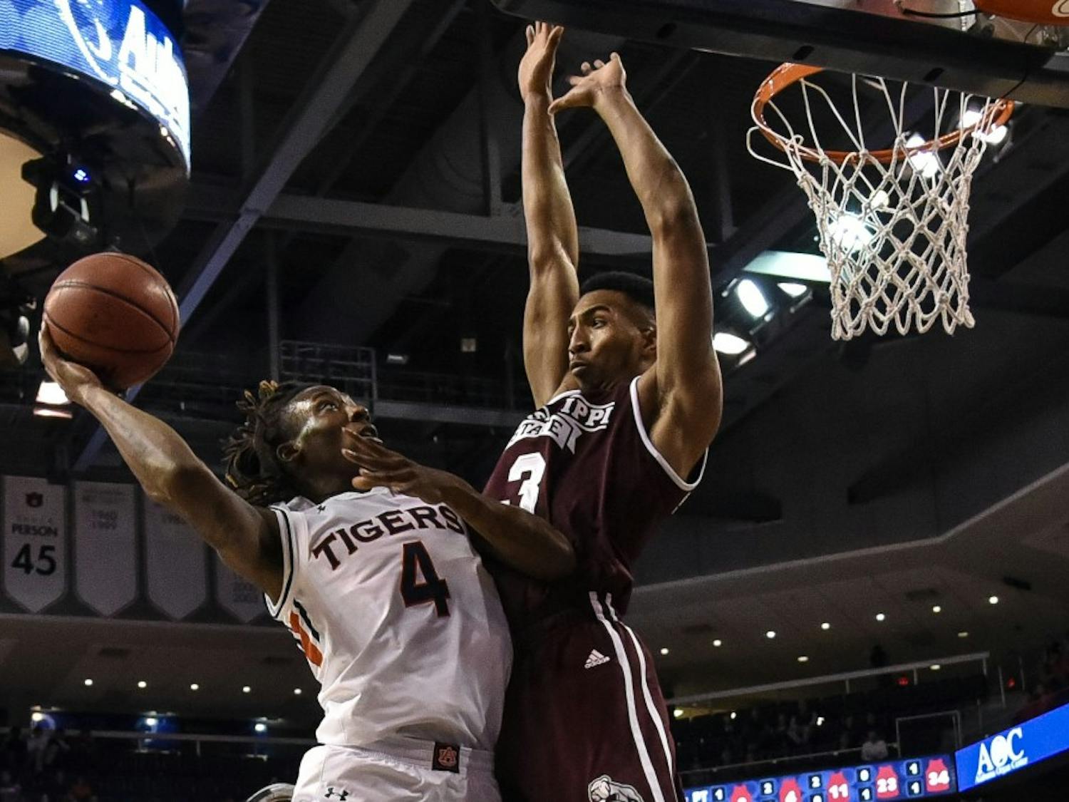Auburn Tigers guard T.J. Dunans (4) goes up against Mississippi State Bulldogs guard Xavian Stapleton (3) during the first half of the Auburn vs Mississippi State basketball on Tuesday, Feb. 7, 2017, in Auburn, Ala.