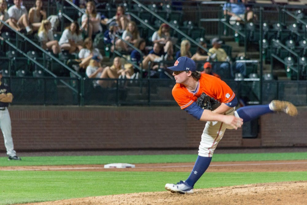Tanner Burns (7) pitches during Auburn baseball vs. Bryant on Saturday, Feb. 24, 2018, in Auburn, Ala.