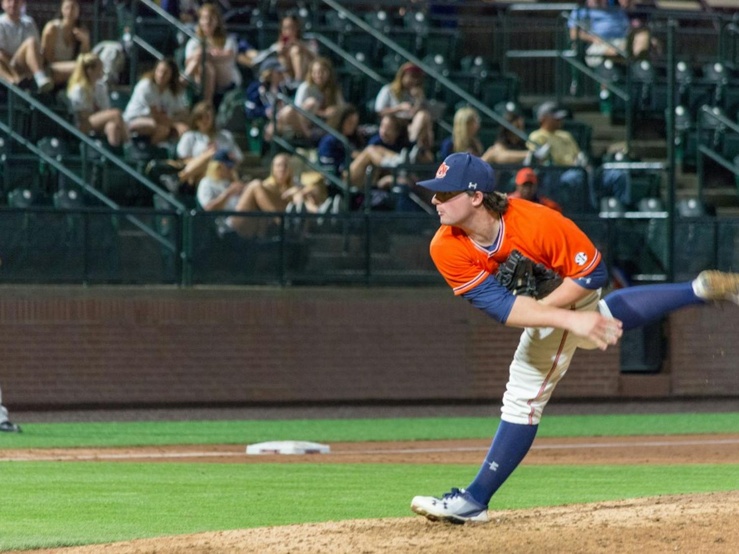 Tanner Burns (7) pitches during Auburn baseball vs. Bryant on Saturday, Feb. 24, 2018, in Auburn, Ala.