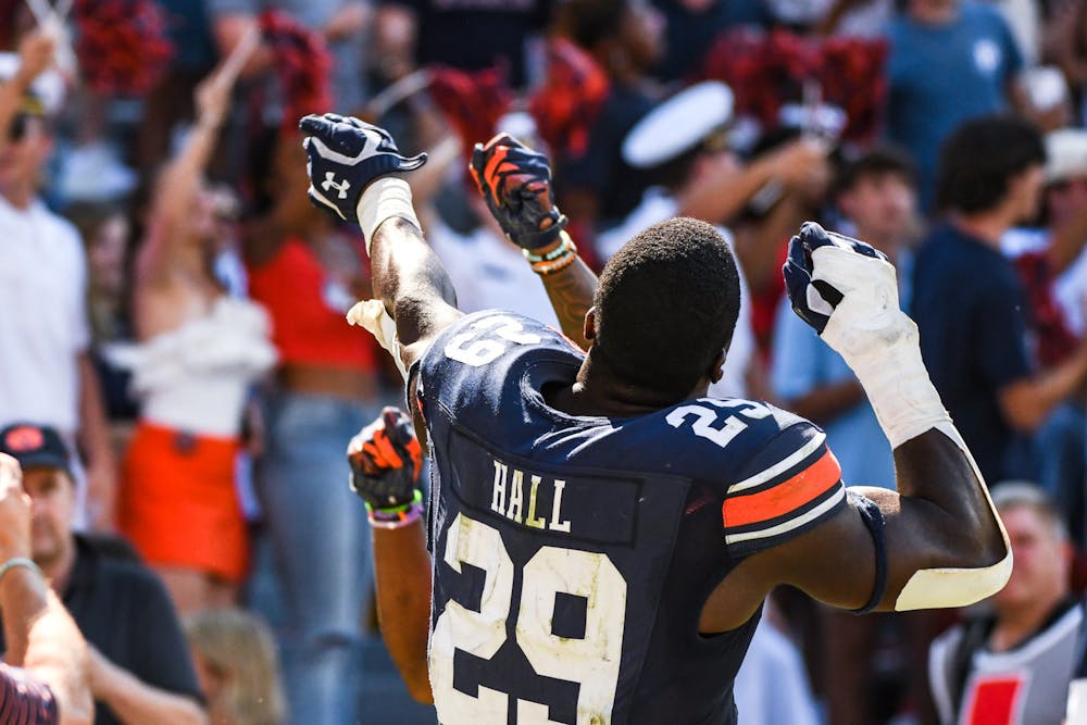 <p>Auburn senior Derick Hall (29) celebrates with his signature bow-and-arrow with teammate Jaylin Simpson after defeating the Missouri Tigers in overtime in Jordan-Hare Stadium on Sep. 24, 2022.</p>