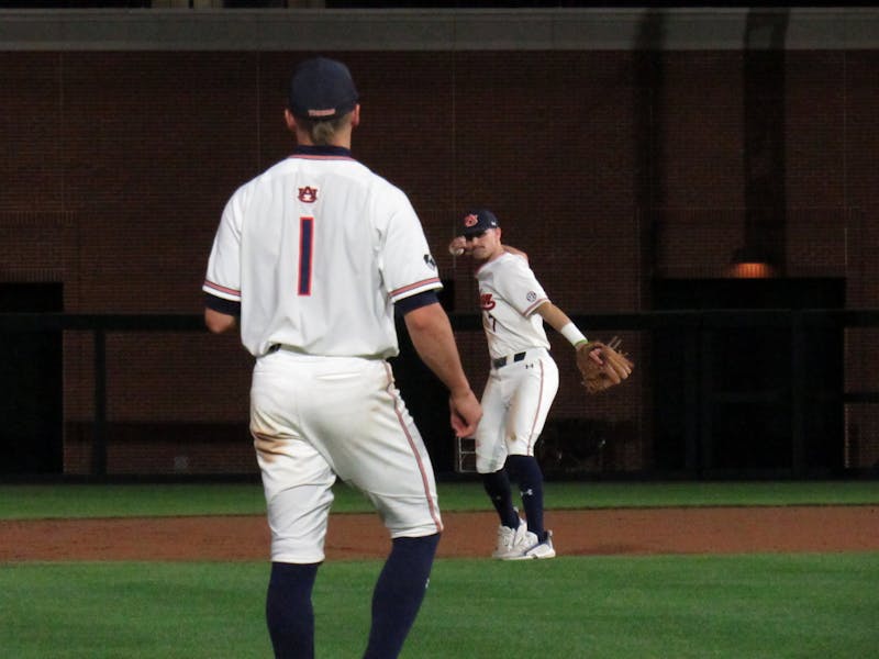 Cole Foster (7) throws the ball to Blake Rambusch (1) during an inning change on March 2, 2022 at Plainsman Park in Auburn, Ala.