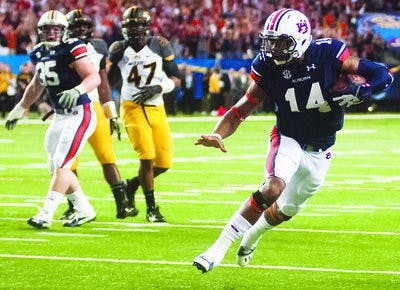 Nick Marshall sidesteps a Missouri defender in the 2013 SEC title game.
