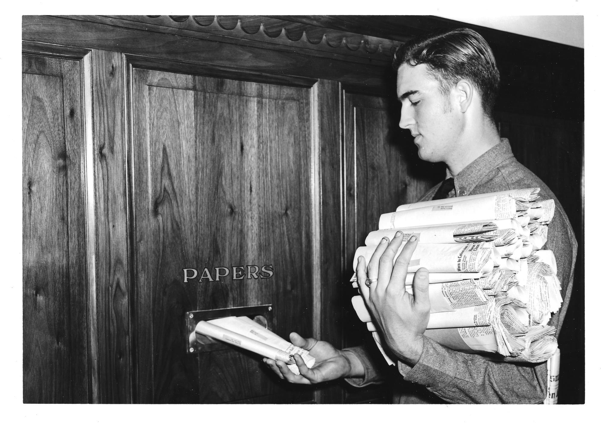 Plains﻿man staff student delivering papers.