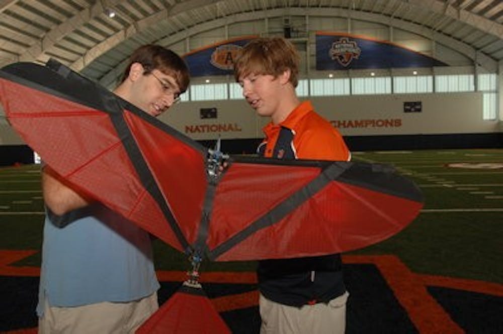 Brian Pappas (left) and Jarred Beck prepare to fly Robo-Nova in Auburn's new practice facility. (Jim Killiam / DIRECTOR OF ENGINEERING COMMUNICATIONS AND MARKETING)