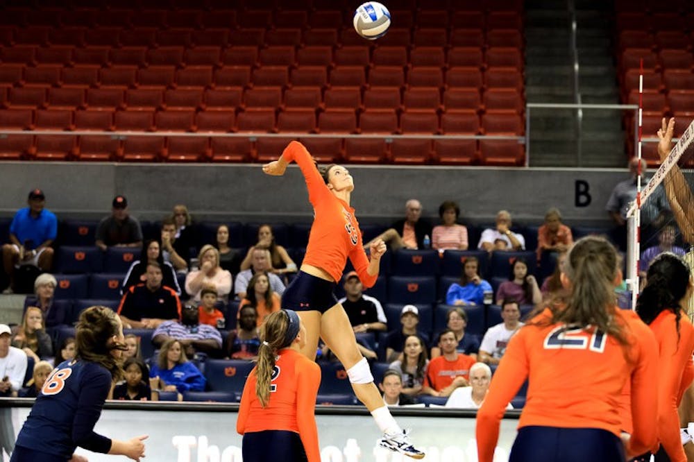 Macy Reece, 33, jumping to hit the ball. (Kenny Moss | Photographer)