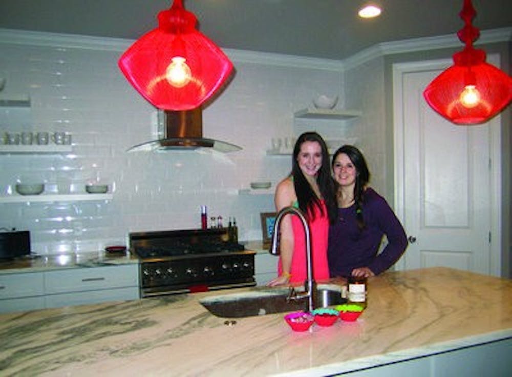 McCauley and Murphy stand in the kitchen where they learned to cook