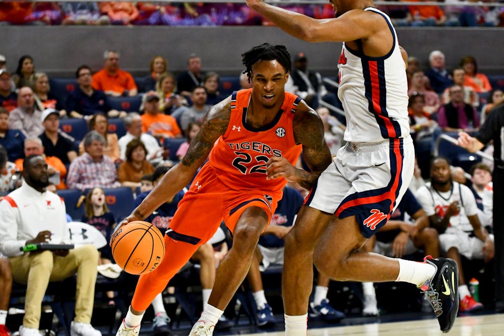 <p>Auburn Men's Basketball Player Allen Flanigan (22) is within seconds of collision with an Ole Miss Player in Neville Arena on Feb. 22, 2023.</p>