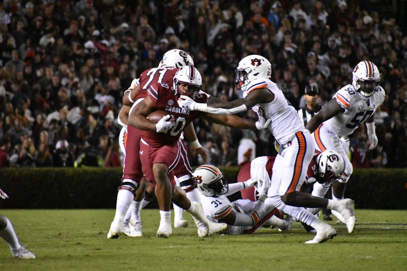 Nov. 20, 2021; Columbia, South Carolina; An Auburn defender gets pushed aside by South Carolina’s Kevin Harris (20) in a match between Auburn and South Carolina.