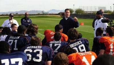 Auburn coach Gene Chizik talks to his team after practice Thursday.(Todd Van Emst / Auburn Media Relations)