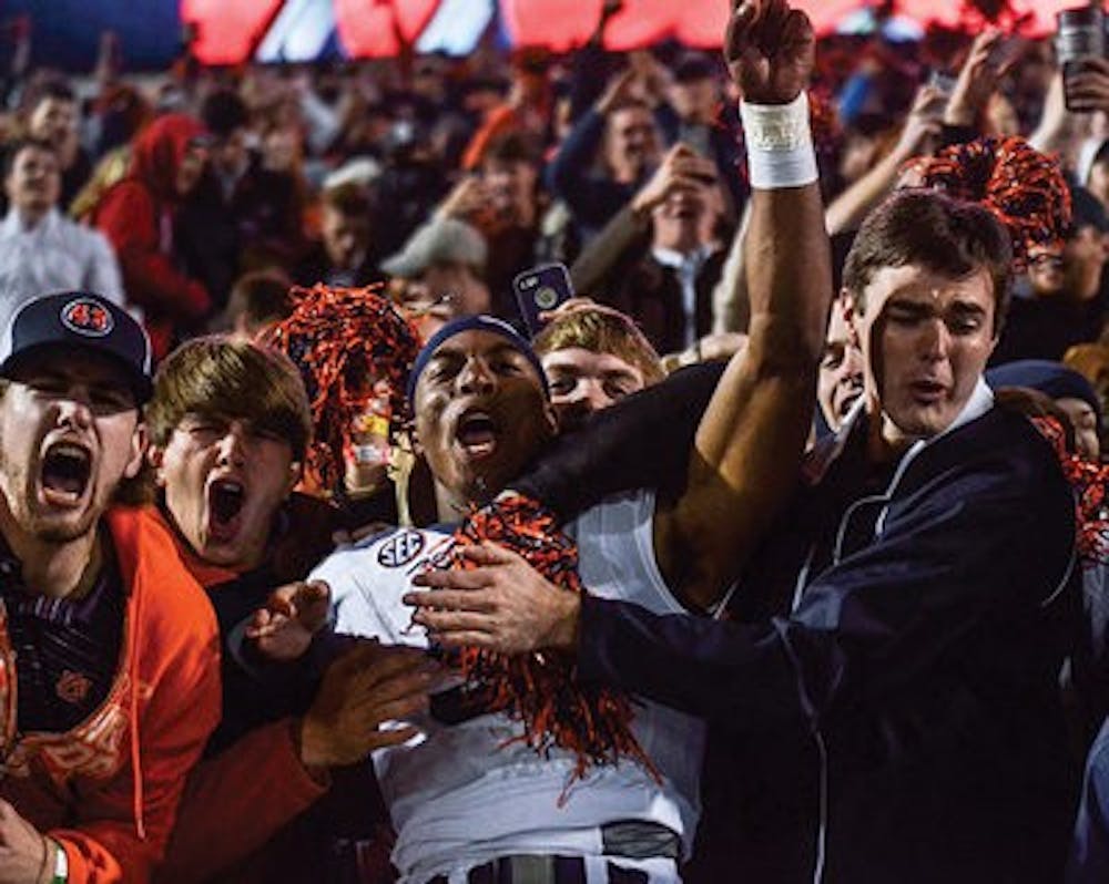 Roc Thomas jumps into the crowd at Ole Miss'  Vaught-Hemingway Stadium. (Raye May / Photo Editor)