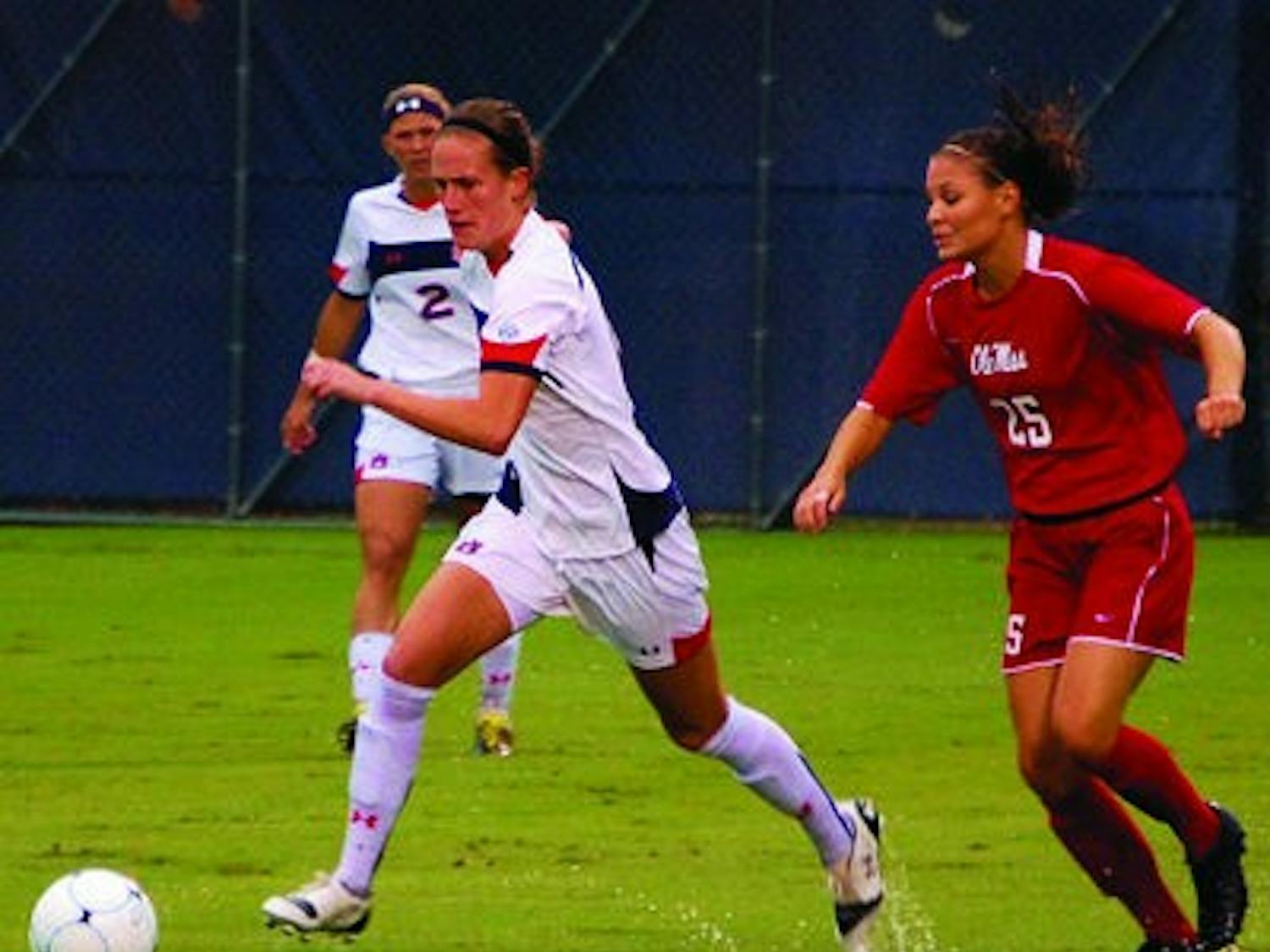 Auburn's Mary Coffed dribbles by an Ole Miss defender. (Katie Shelton/ Photo Staff)
