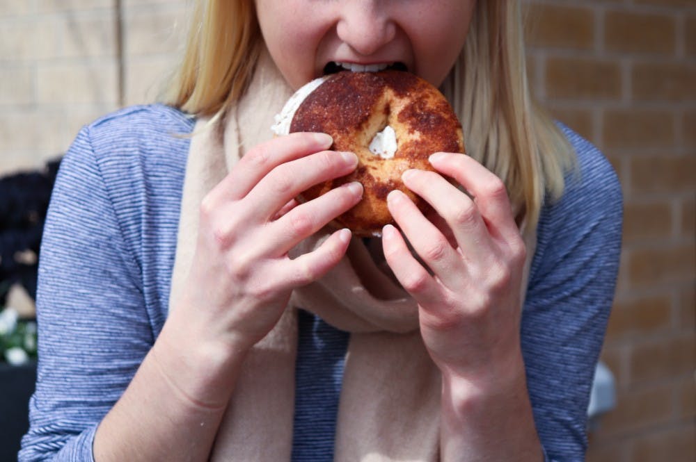 An Auburn University Student eats a bagel from Einstein Bros. Bagels on Feb. 1, 2019, in Auburn, Ala.