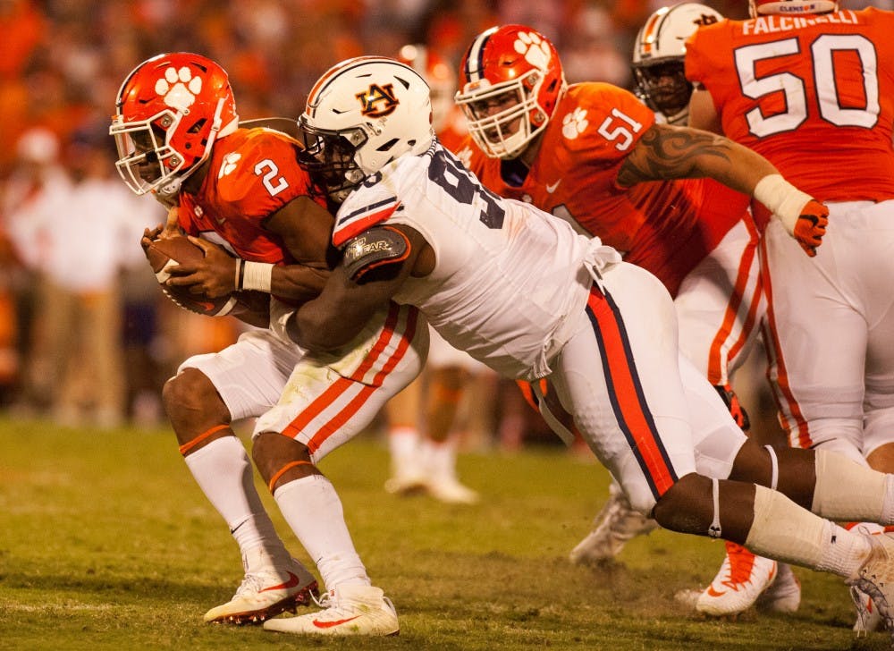 Auburn defensive lineman Dontavius Russell (95) tackles Clemson quarterback Kelly Bryant (2) in the second half. Auburn vs Clemson on Saturday, Sept. 9 in Clemson, S.C.