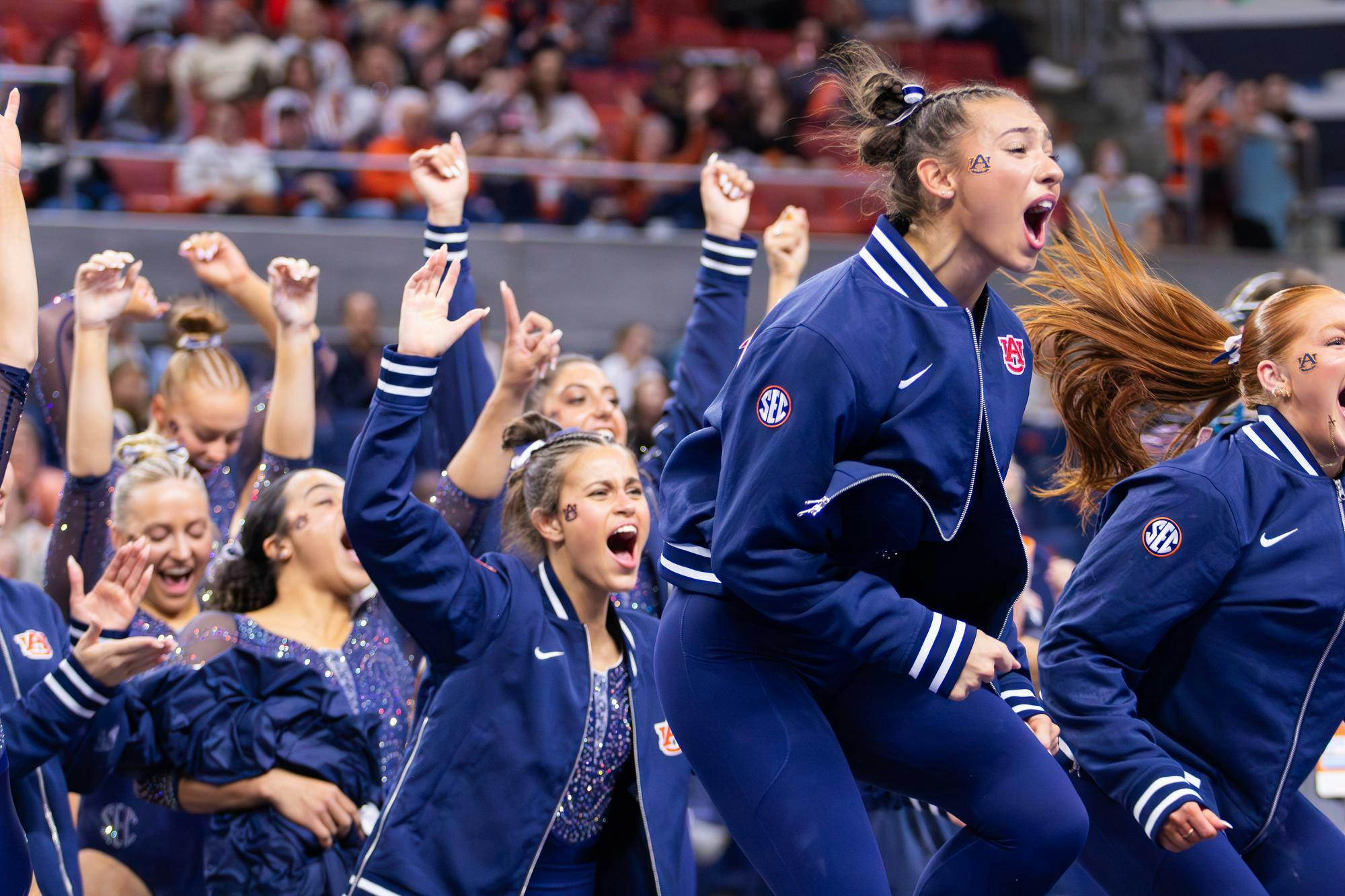 The gymnastics team cheers for one of their teammates after she performed her vault routine during the meet against Florida on Jan. 23, 2026 in Neville Arena in Auburn, Ala.