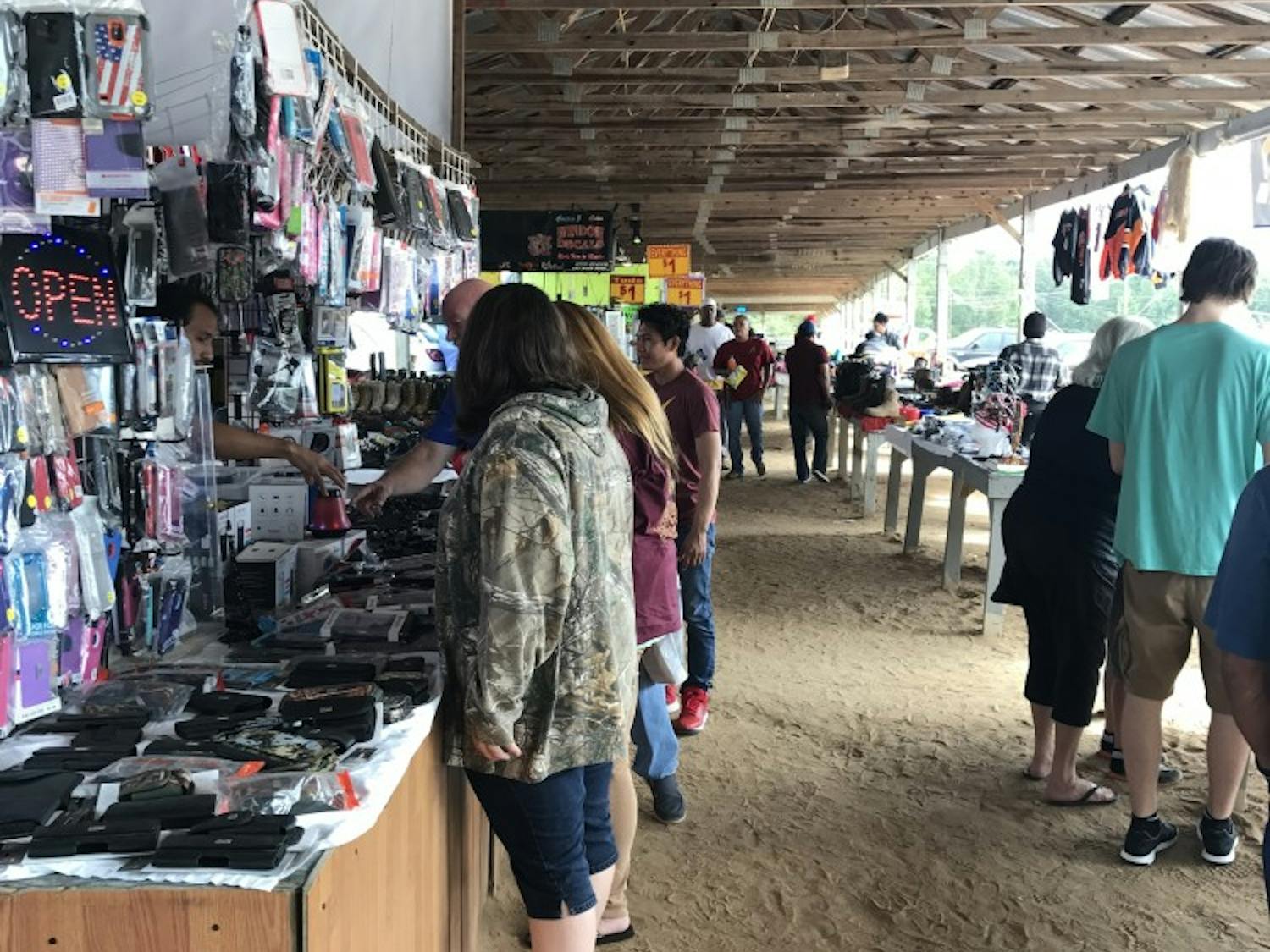 Shoppers browse tables at the Lee County Flea Market in Lee County, Ala.