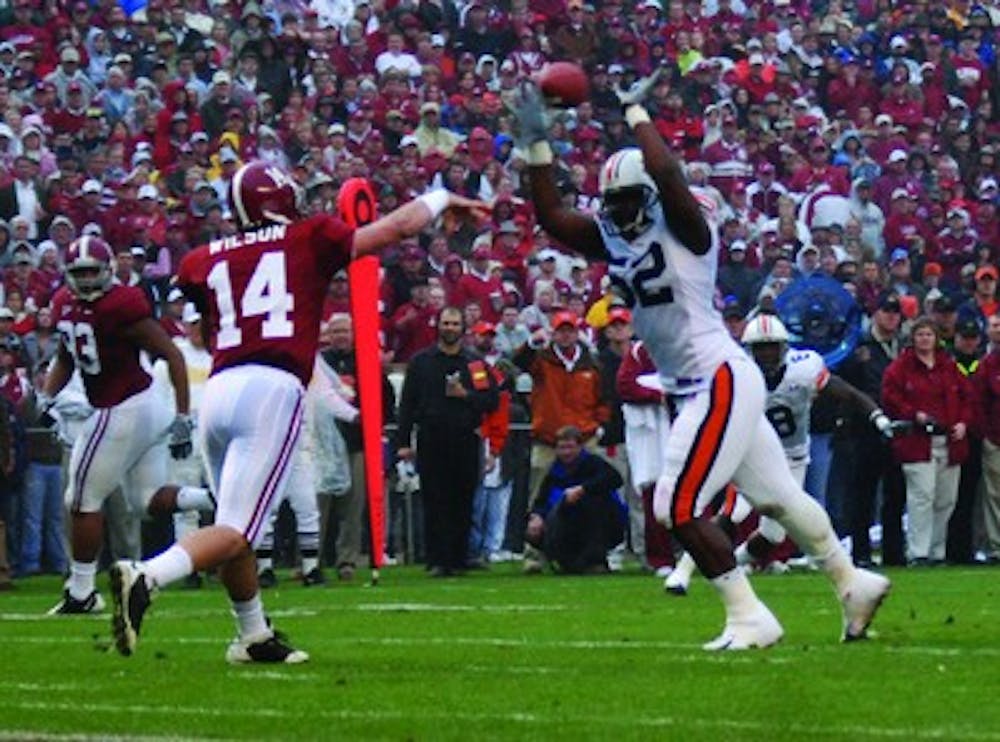 Antonio Coleman, No. 52, gets in the face of Alabama's John Parker Wilson during last year's Iron Bowl. The 2009 game will now be held the day after Thanksgiving. Rod Guajardo / Assistant Photo Editor