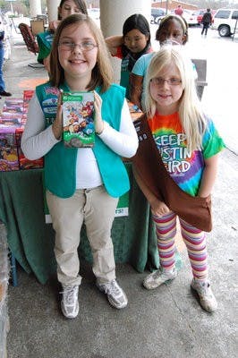 Junior Girl Scout Faith Leverette and Brownie Girl Scout Brenna Carr from Troop 7047 participate in their troop's last cookie booth sale of the year. (Lindsay Rife / Associate Intrigue Editor)