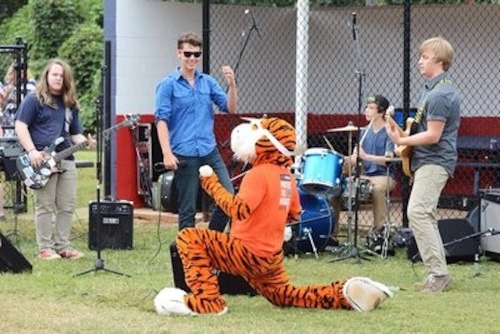 Singer Liam McGlynn performs alongside Aubie during one of his Amplify Auburn shows. (Contributed by Tricia Oliver)