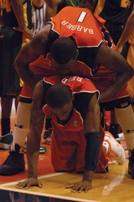 Korvotney Barber, No. 1, tries to console DeWayne Reed, No. l2, after the end of Tuesday night's heartbreaker loss to Baylor. The Bears moved on to the semifinals of the NIT Tournament.