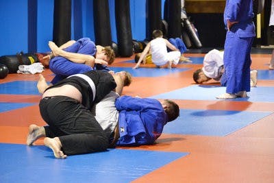 Auburn MMA members get their exercise by fighting friendly during the classes offering at the gym. Classes include MMA, Brazilian Jui Jitsu, fitness kickboxing, female fitness kickboxing and Muay Thai. (Raye May / PHOTO EDITOR)