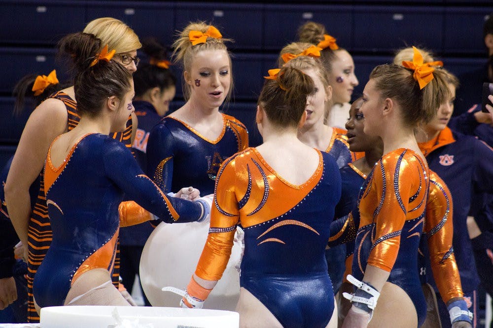 Auburn gymnastics team huddles around the chalk bowl prior to the Valentine's Day meet. Jenna Burgess / PHOTOGRAPHER