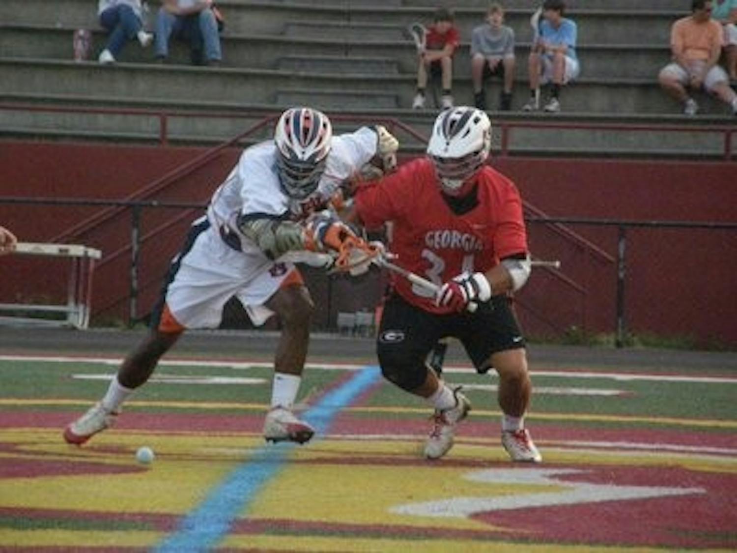 Mshon Pulliam, senior midfielder, battles with a Georgia opponent for position during a match last season. (CONTRIBUTED)