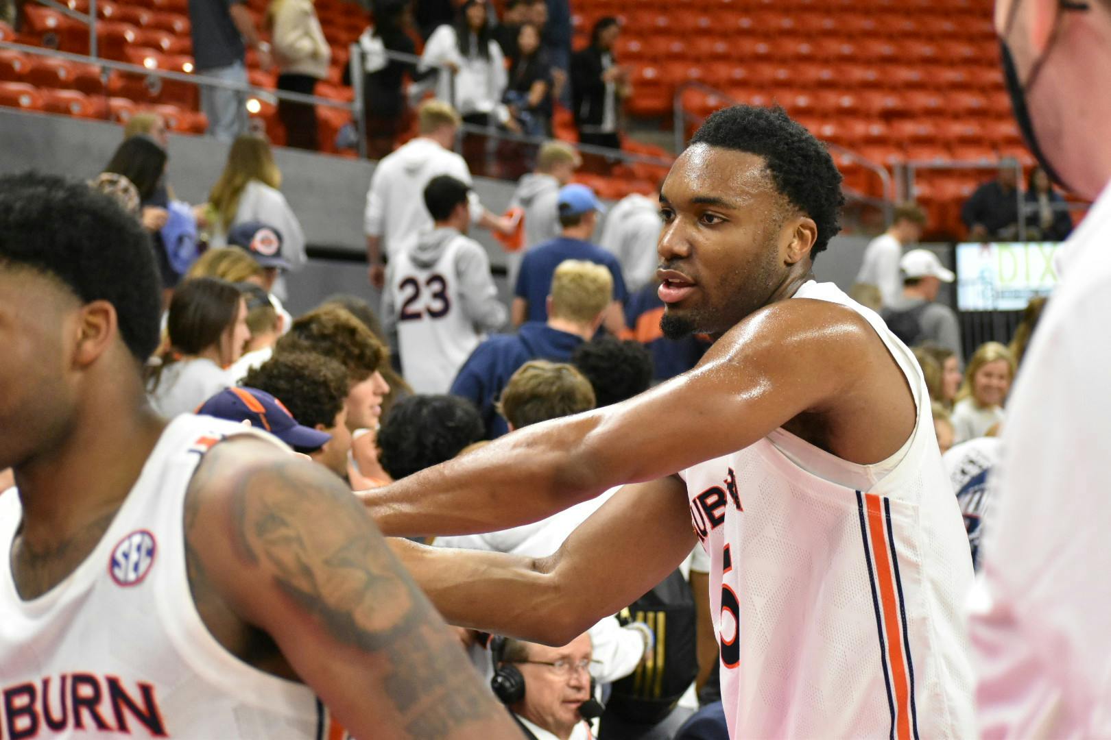 basketball players high five fans