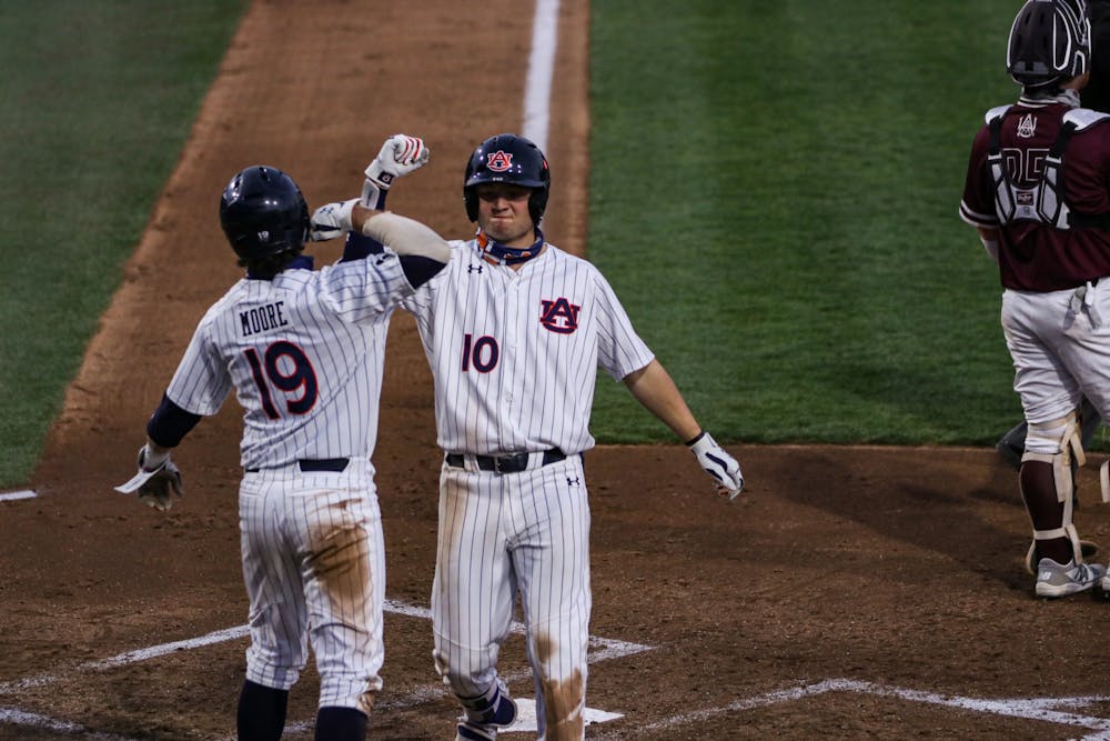 <p>Auburn Tigers infielder/outfielder Tyler Miller (10) and Auburn Tigers infielder Brody Moore (19) react after a run scores during the game between Auburn and Alabama A&amp;M on Feb 24, 2021; Auburn, AL, USA. Photo via: Jacob Taylor/AU Athletics</p>