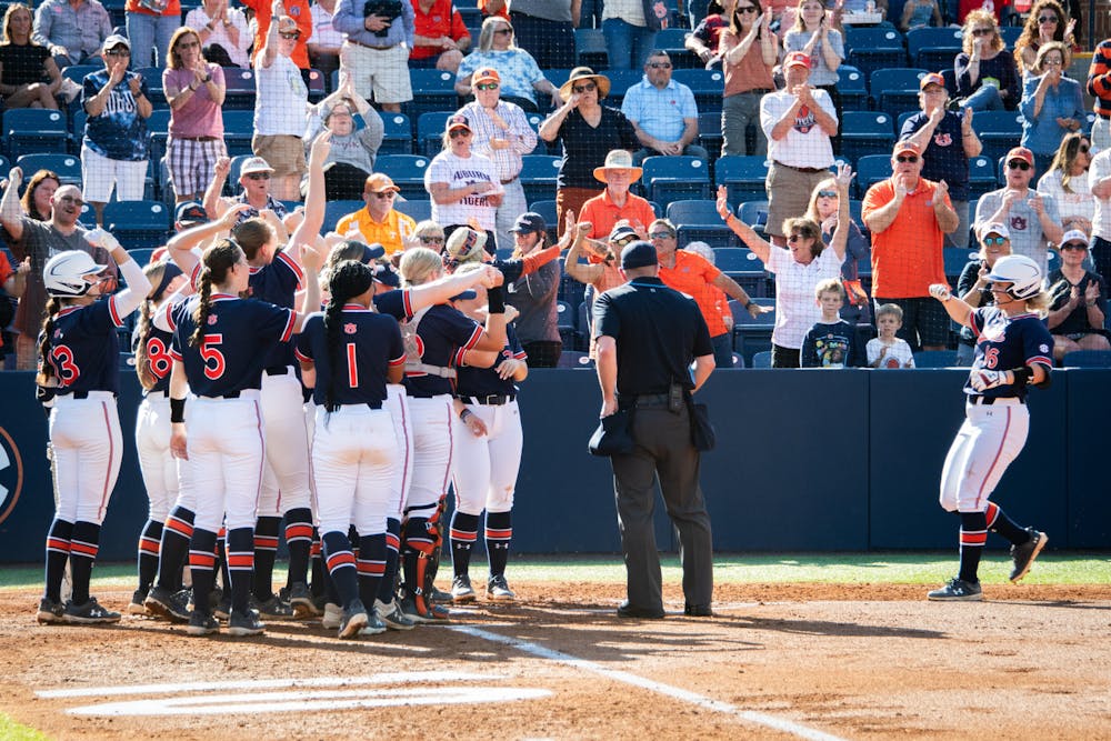 <p>KK McCrary (16) closing in on home plate to the cheering of her teammates after hitting the first home run for the Auburn Tigers during their second softball match against the Tennessee Lady Vols, March 30, 2024.</p>