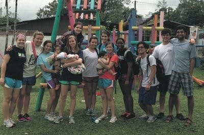 Aeikens and the ASB group hang out on the playground with children at the orphanage in Nicarauga. (Courtesy of Brianne Aeikens)