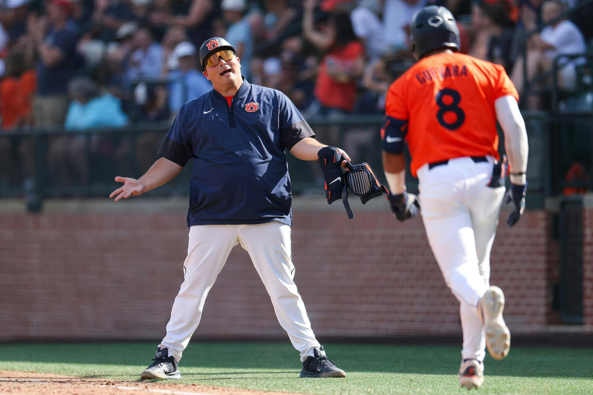 AUBURN, AL - APRIL 26 - Auburn Student Assistant Coach Sonny DiChiara, Auburn's Eric Guevara (8) - #6 Auburn Tigers vs. #9 Oklahoma Sooners at Plainsman Park in Auburn, AL on Sunday, April 26, 2026. Photo by Zach Bland/Auburn Tigers